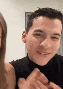a man and a woman are sitting next to each other and the man is smiling .