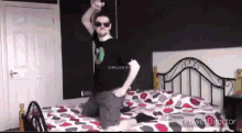 a man is jumping on a bed in a bedroom .