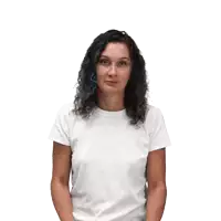 a woman in a white shirt is shrugging her shoulders and making a funny face