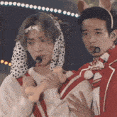 a man in a dalmatian costume is holding another man 's hand