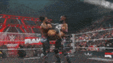 a wrestler is laying on the ground in a ring with the word raw on the bottom
