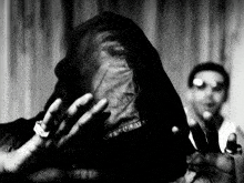 a black and white photo of a person with a veil on their face