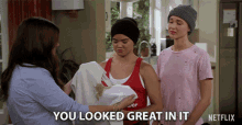 a netflix ad shows a woman holding a dirty shirt and says you looked great in it