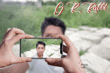 a person taking a picture of a man with the name g.r. rabbit written on the bottom