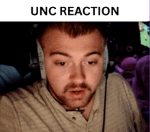 a man wearing headphones with the words " unc reaction " below him