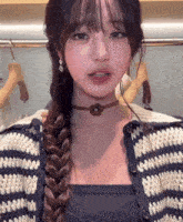 a woman wearing a choker and a striped sweater