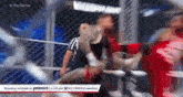 a referee is standing in a cage watching a wrestling match between two wrestlers .