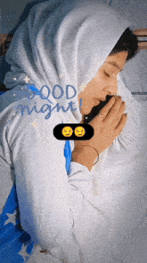 a woman in a white hijab is sleeping with the words good night written above her