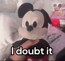 a person holding a stuffed mickey mouse with the words " i doubt it " above it