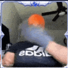 a person wearing a black shirt with the word adidas on it