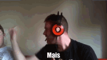 a man wearing headphones has the word mais written on his face