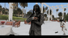 a man with dreadlocks is standing in a video game