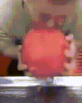 a blurred image of a person holding a red object