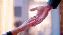 a man and a woman are holding hands in a room