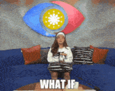 a woman sitting on a couch with a microphone and the words what if on the table