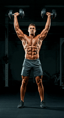 a shirtless man is lifting dumbbells in a gym