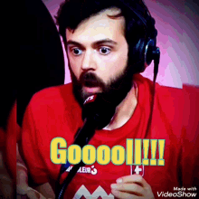 a man wearing headphones and a red shirt that says aleur