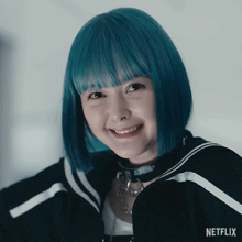 a woman with blue hair is smiling and wearing a netflix logo