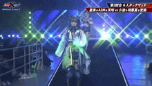 a female wrestler walks down a stage with a sign that says historic x-over 7