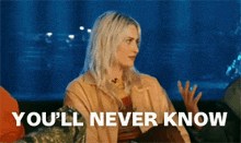 a woman in a tan jacket says you 'll never know