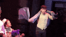 a man with a scarf around his neck is on stage