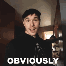 a man wearing a black shirt with the word obviously written on it
