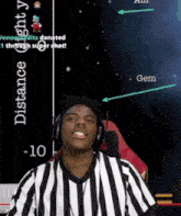 a man wearing headphones stands in front of a screen that says distance -10 and gem