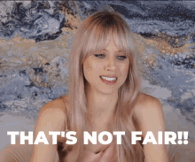 a woman says that 's not fair in front of a blue background