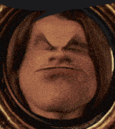 a close up of a man 's face with a very angry expression