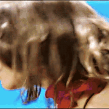 a blurry picture of a woman 's head with a blue background
