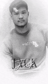 a black and white photo of a man with the name jack on his shirt