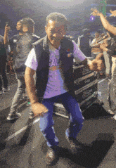 a man wearing a shirt that says cal is dancing