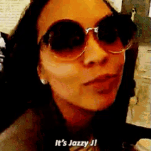 a woman wearing sunglasses says it 's jazzy j '