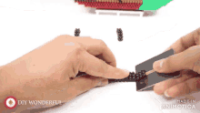 a person is holding a card with the words made in animatica on it