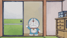 a cartoon character named doraemon is standing in a room with a green door