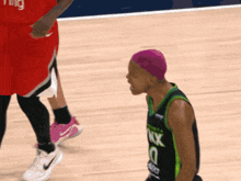 a basketball player wearing a purple headband and a jersey that says nx