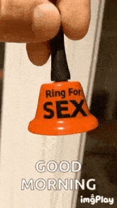 a person is holding a bell that says `` ring for sex `` .