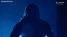 a peacock logo can be seen in the corner of the image