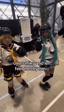 two people dressed as oilers miku and len are dancing together