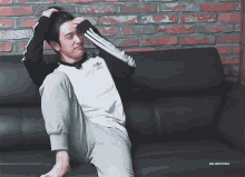 a man sitting on a couch with the name jinyoung on the bottom right
