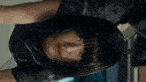 a close up of a person 's face with a black shirt