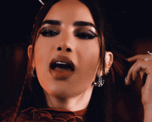 a close up of a woman 's face with her tongue sticking out