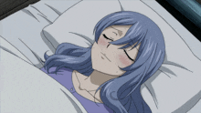 a woman with blue hair is sleeping on a bed
