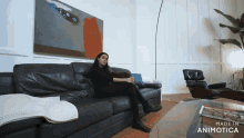 a woman sits on a black leather couch in a living room made in animatica