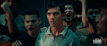a poster for kahar shows a group of men screaming in a dark room