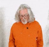 an older man wearing glasses and an orange hoodie
