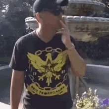 a man wearing a t-shirt that says obey propaganda on it