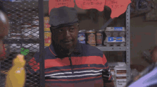 a man standing in front of a sign that says tea
