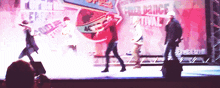a group of people are dancing on a stage in front of a sign that says " free dance festival "