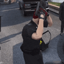 a police officer holding a gun with a badge that says ' s.w. ' on it